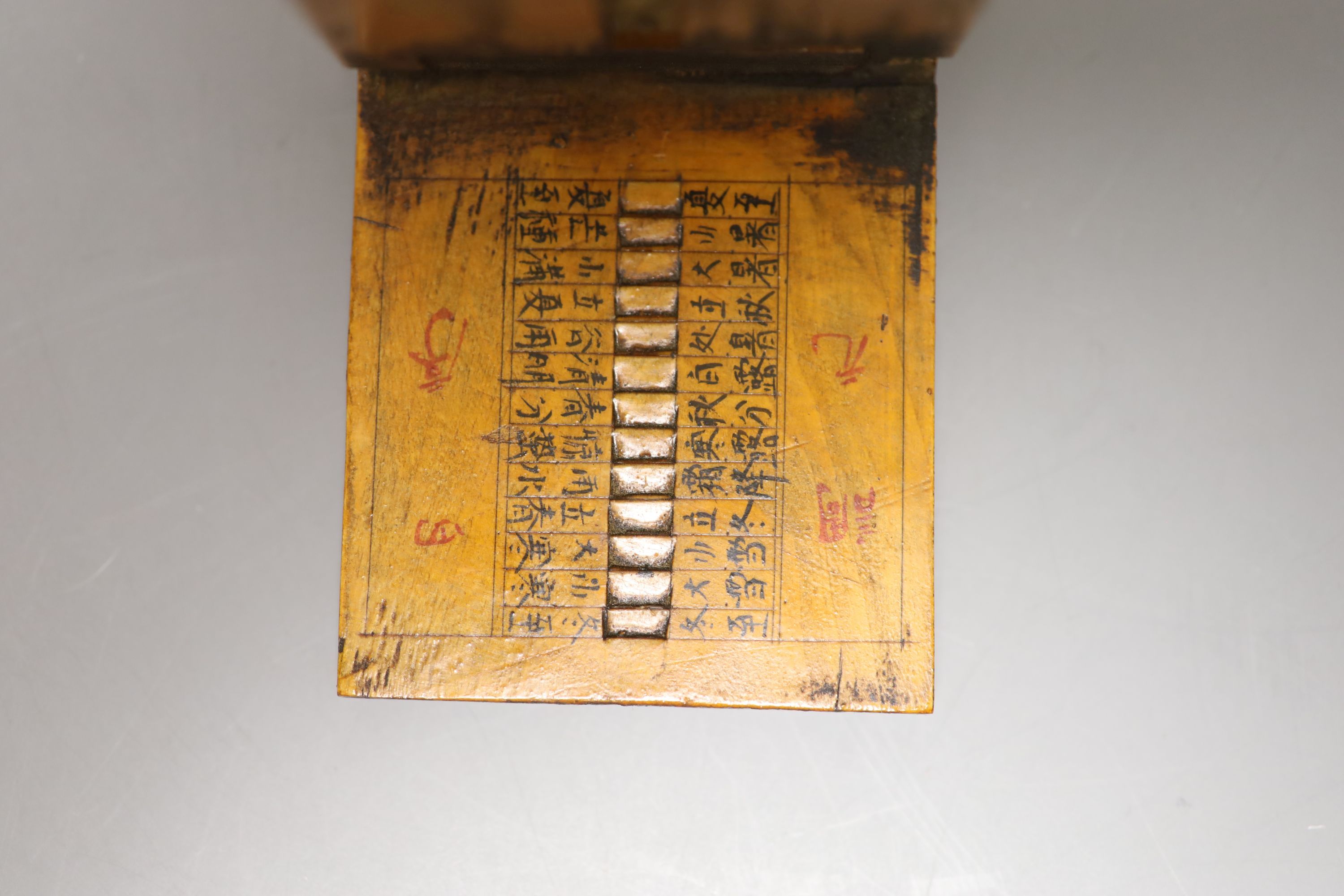 A reproduction Butterfield style scale and a Chinese compass/sundial, longest 12cm